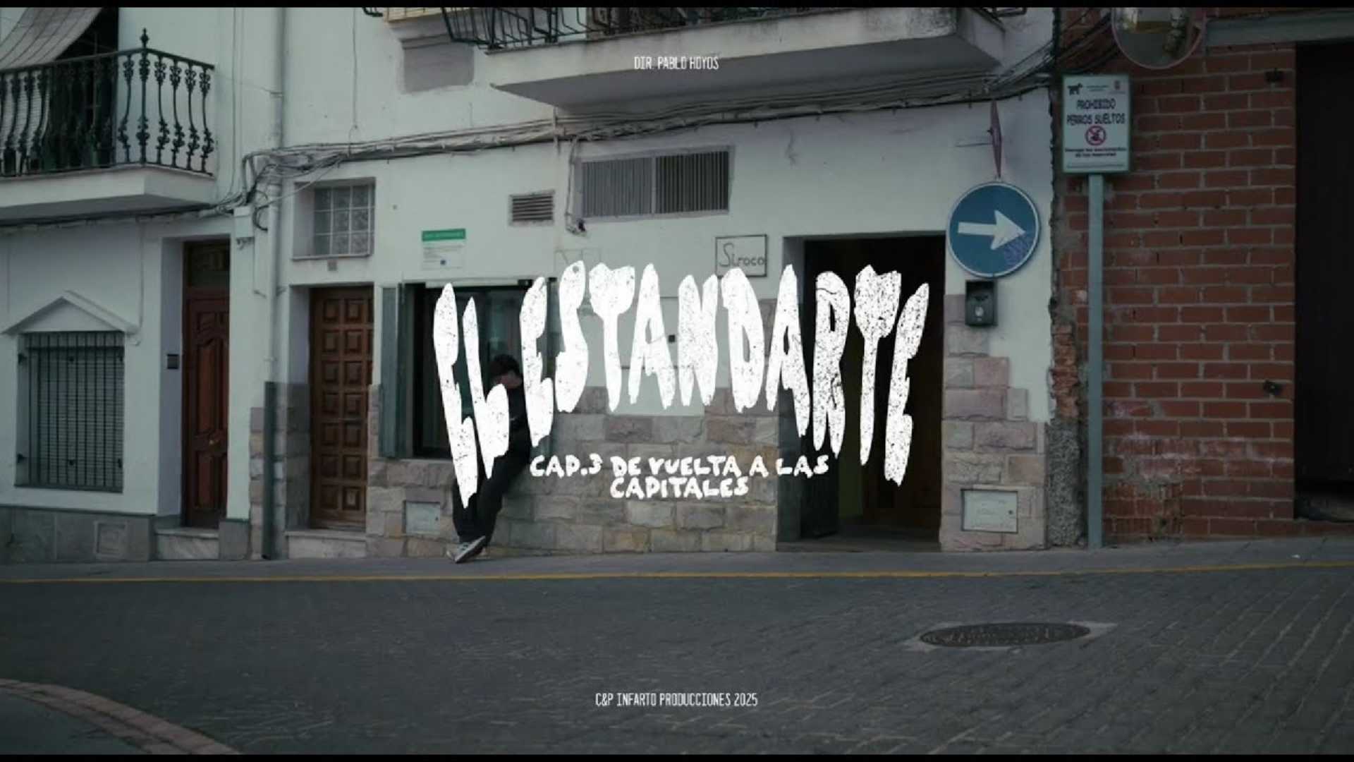 Persona caminando por una calle del pueblo con el título “El Estandarte” y el texto “Cap. 3: De vuelta a las capitales